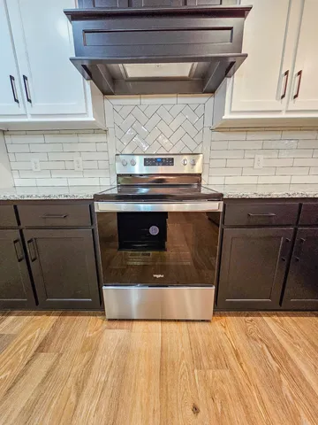 a stove top oven sitting inside of a kitchen