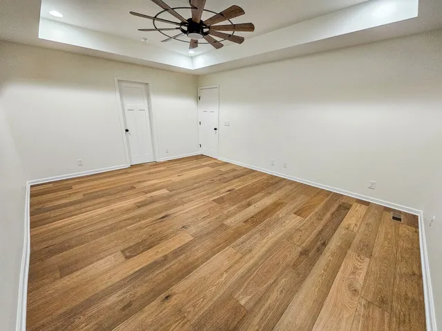 a view of a room with wooden floor