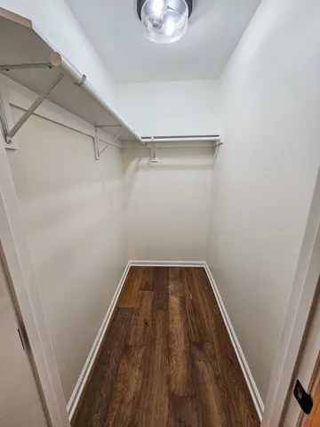 a view of walk in closet with empty racks