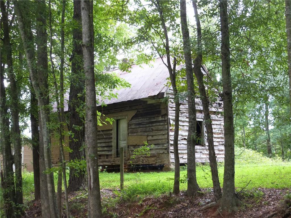 1650 Locklin Cemetery Road Monroe, GA 30655 - Photo 31 of 72 a view of a house with a tree in the forest