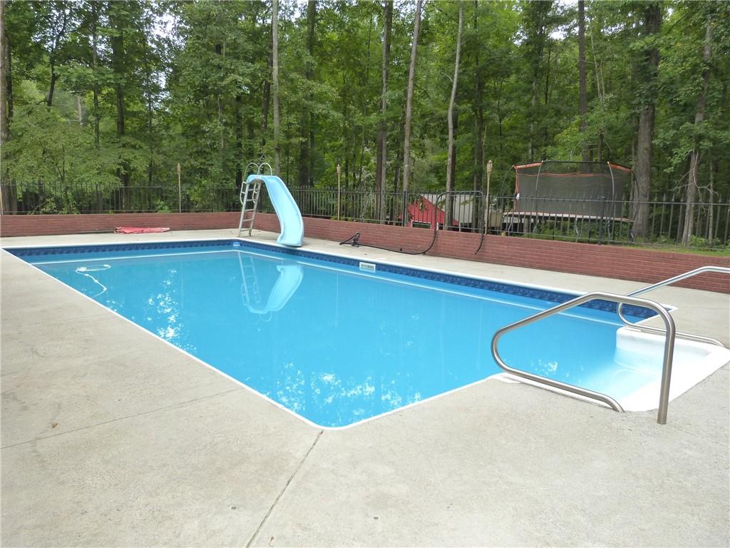 1650 Locklin Cemetery Road Monroe, GA 30655 - Photo 45 of 72 a view of a swimming pool with a yard and sitting area