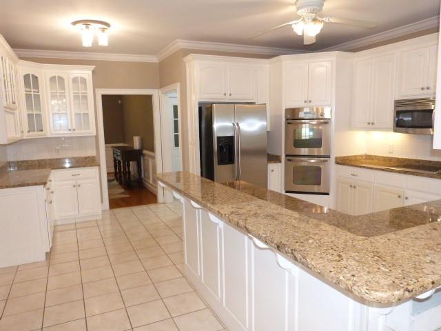 1650 Locklin Cemetery Road Monroe, GA 30655 - Photo 51 of 72 a large kitchen with kitchen island granite countertop a sink cabinets and stainless steel appliances