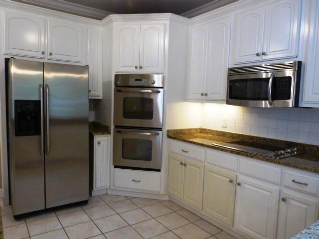 1650 Locklin Cemetery Road Monroe, GA 30655 - Photo 52 of 72 a kitchen with white cabinets and stainless steel appliances