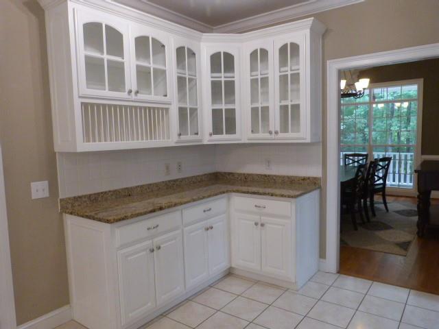 1650 Locklin Cemetery Road Monroe, GA 30655 - Photo 54 of 72 a kitchen with granite countertop white cabinets and dining table