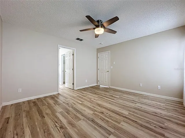 a view of an empty room and wooden floor