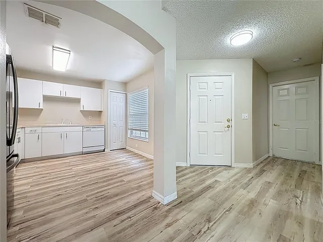 a large kitchen with cabinets and stainless steel appliances