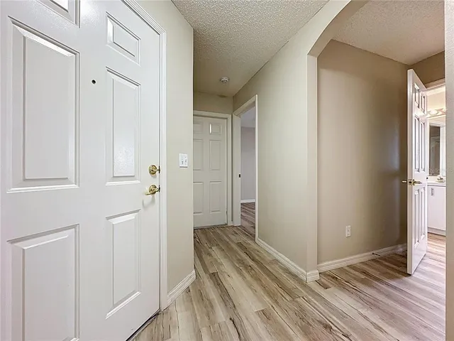 a kitchen with a white cabinets and wooden floor