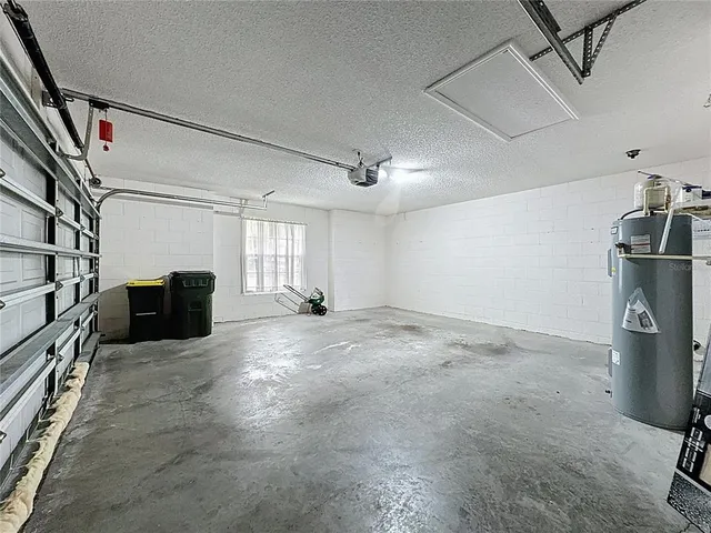 a front view of a house with a garden and trees