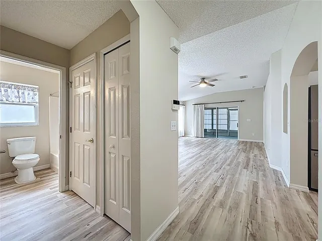 a large hall with stainless steel appliances granite countertop lots of wooden furniture