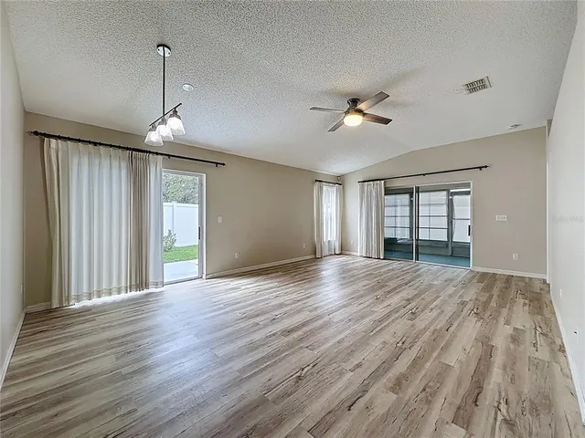 a kitchen with a table chairs refrigerator and cabinets