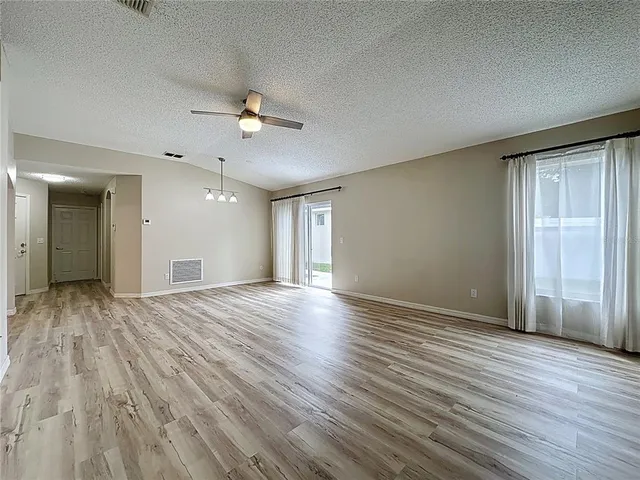 a tennis court with view of trees in the background