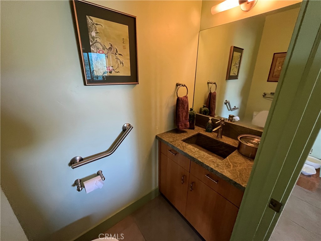 240 Rich Gulch Road Oroville, CA 95965 - Photo 17 of 49 a bathroom with a granite countertop sink a mirror and vanity