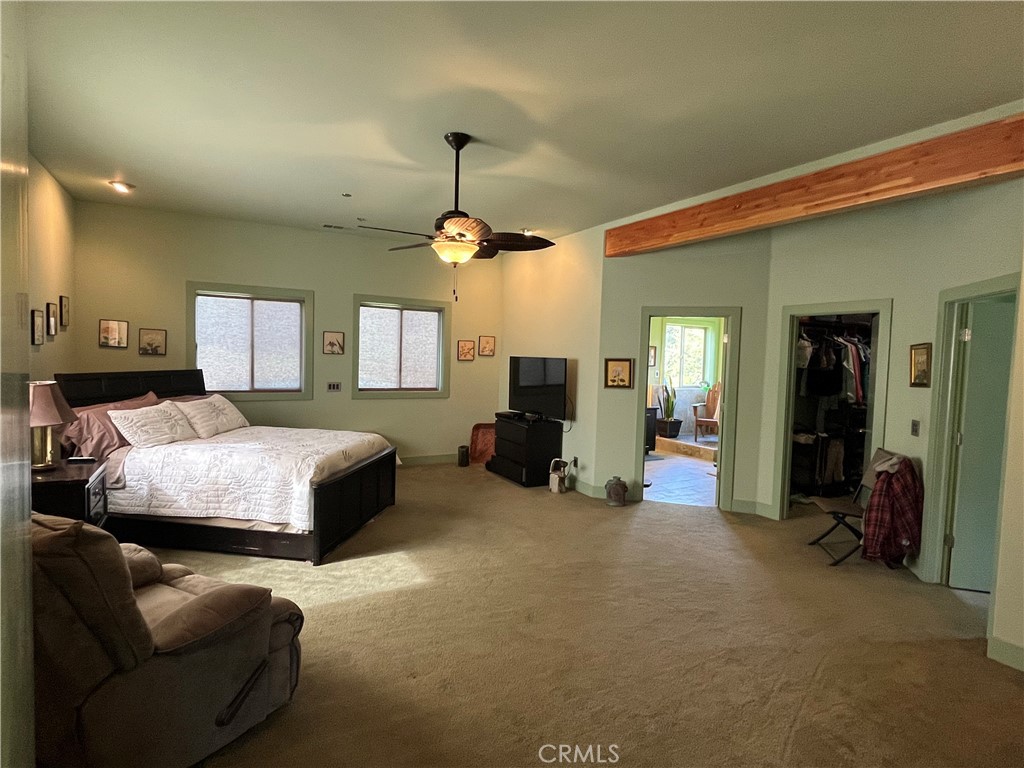240 Rich Gulch Road Oroville, CA 95965 - Photo 21 of 49 a spacious bedroom with a bed a couch and dresser