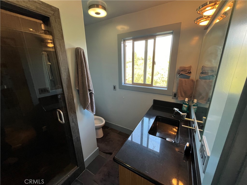 240 Rich Gulch Road Oroville, CA 95965 - Photo 40 of 49 a bathroom with a toilet a sink and a mirror