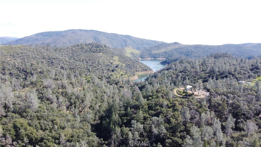 240 Rich Gulch Road Oroville, CA 95965 - Photo 5 of 49 a view of a dry yard with mountains in the background