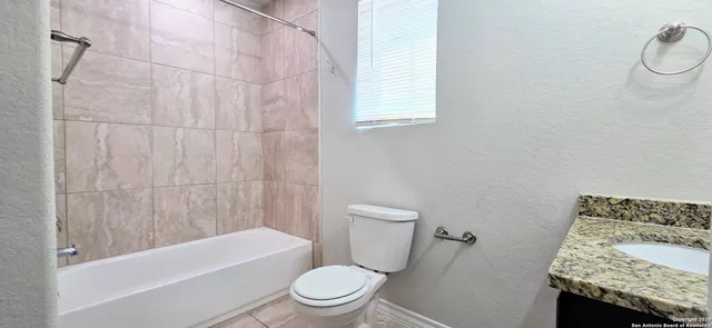 a bathroom with a toilet and a bathtub