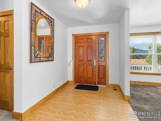 a view of an entryway with wooden floor