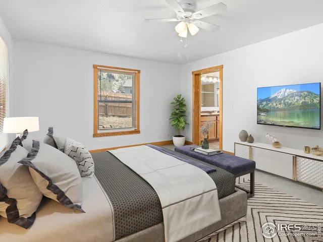 a bedroom with a bed and a flat screen tv