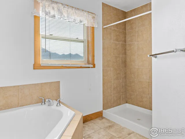 a bathroom with a tub and a shower