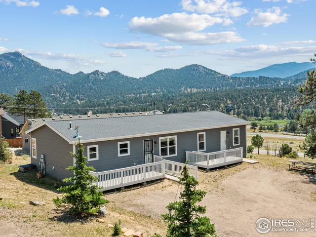 a view of a house with a mountain in the background