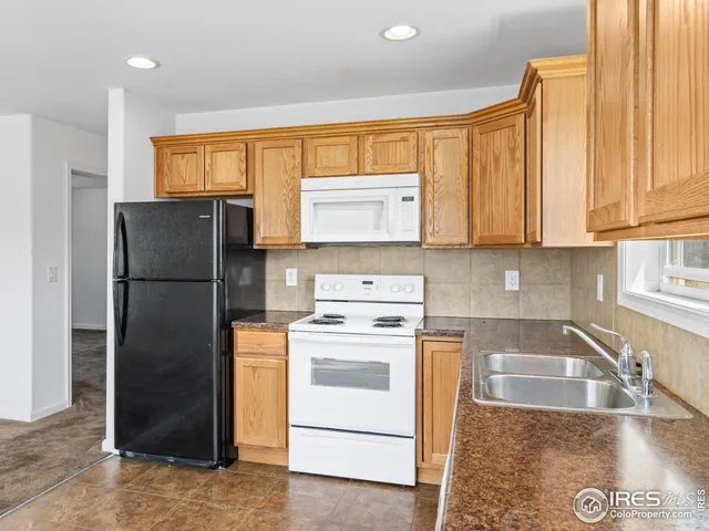 a kitchen with a refrigerator stove and sink