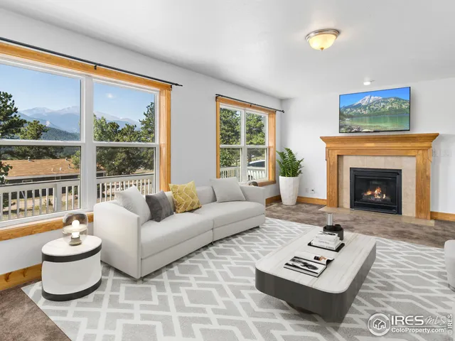 a living room with furniture a floor to ceiling window and a fireplace