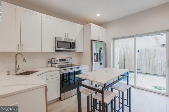 a kitchen with a stove a sink and a refrigerator