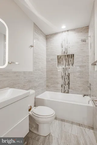 a bathroom with a bathtub and shower