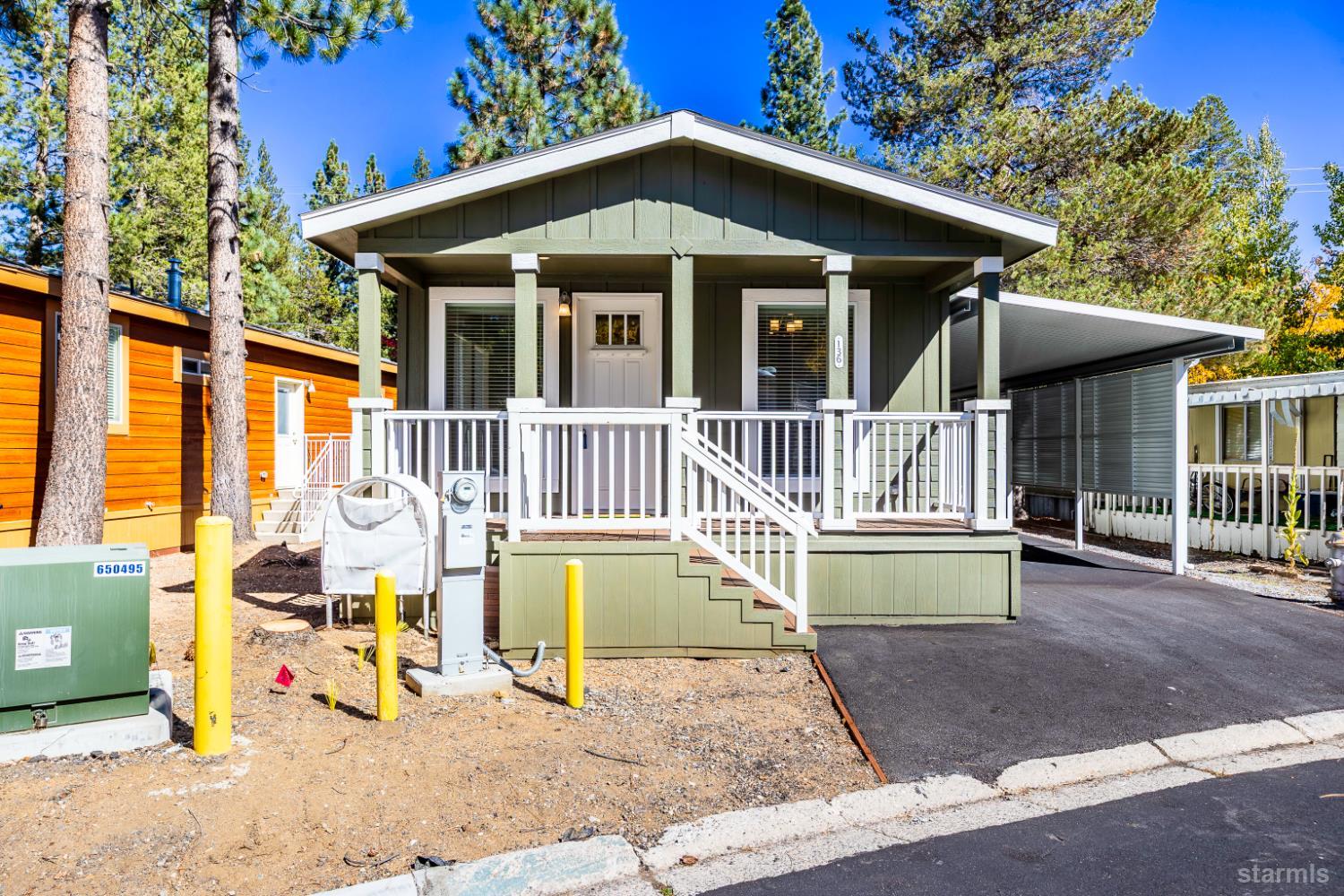 a view of a house with a yard deck and furniture