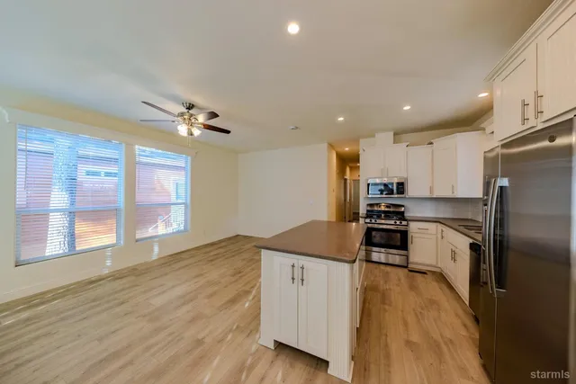 a kitchen with stainless steel appliances a refrigerator sink and stove