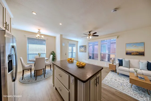 a view of a kitchen and a kitchen with wooden floor