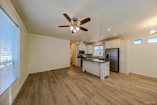a kitchen with a refrigerator and a stove top oven