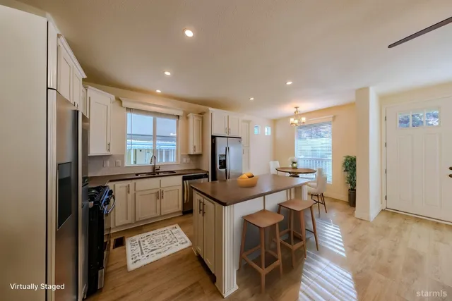 a kitchen with stainless steel appliances granite countertop refrigerator sink and stove