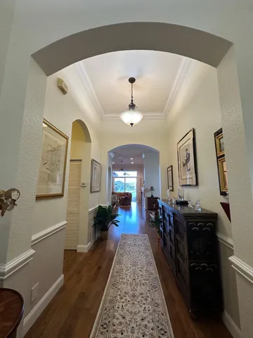 a living room with furniture and a baby crib