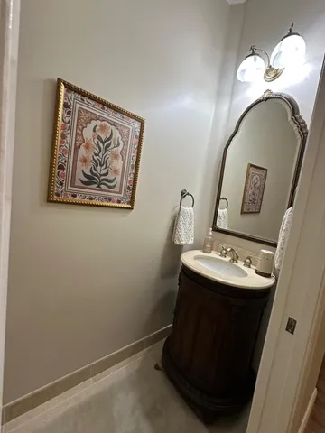 a white toilet sitting next to a white wall