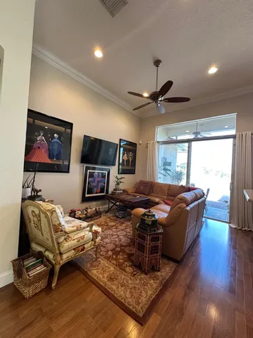 a kitchen with stainless steel appliances granite countertop wooden floors and white cabinets