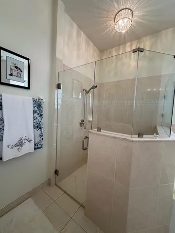 a spacious bathroom with a tub a sink and mirror