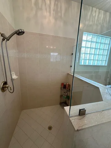 a bathroom with a toilet and a shower