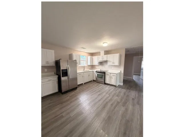 a kitchen with stainless steel appliances a refrigerator and a sink