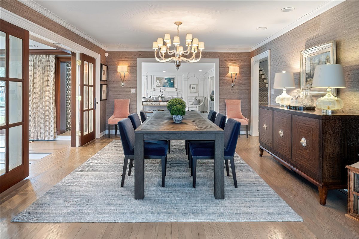 45 Woodley Road Winnetka, IL 60093 - Photo 12 of 61 a dining room with wooden floor a chandelier a wooden table and chairs