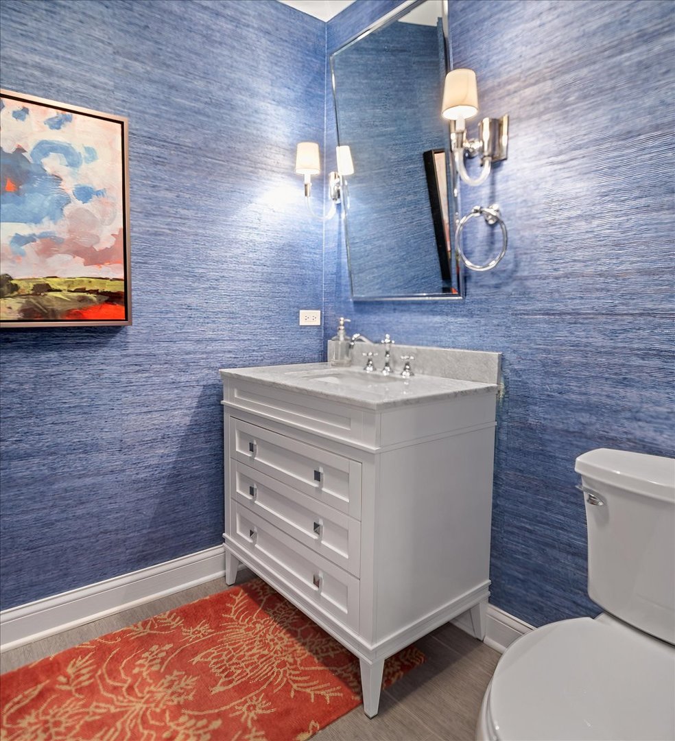45 Woodley Road Winnetka, IL 60093 - Photo 34 of 61 a bathroom with a sink a toilet and mirror