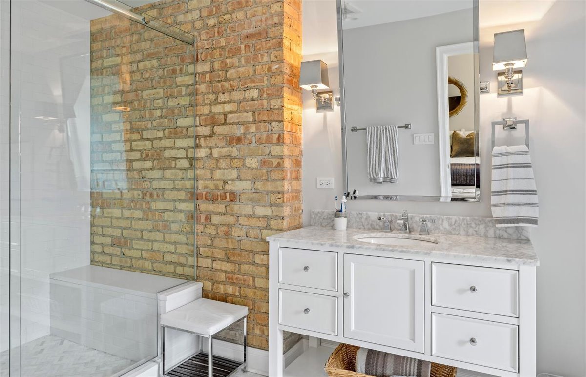 45 Woodley Road Winnetka, IL 60093 - Photo 48 of 61 a bathroom with a sink and a mirror