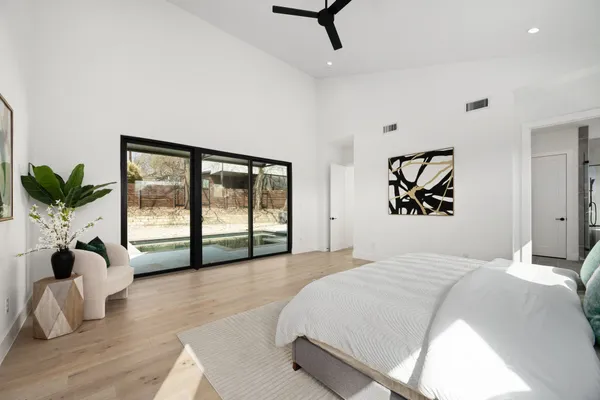 a bedroom with a large bed and a large window