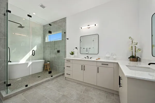 a spacious bathroom with double sink and a mirror