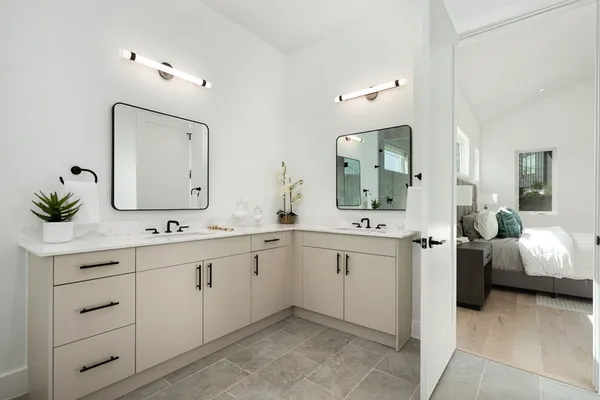 a spacious bathroom with a granite countertop sink and a mirror