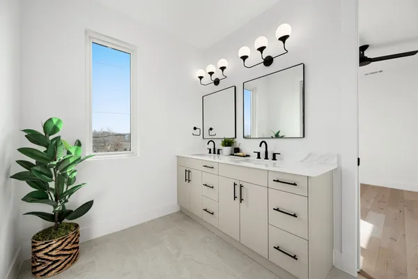 a view of empty room with wooden floor and ceiling fan