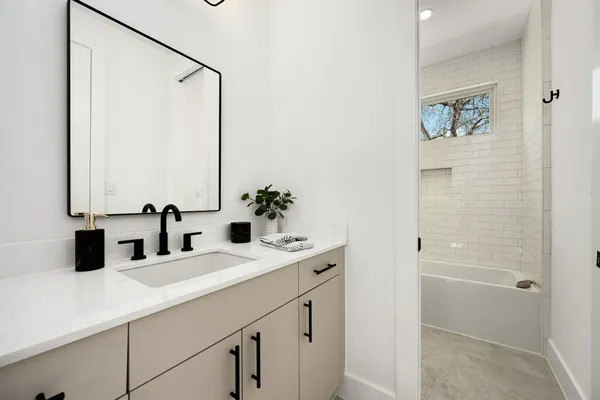 an empty room with wooden floor ceiling fan and window