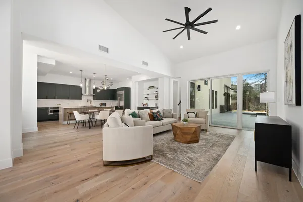 a living room with furniture and view of kitchen
