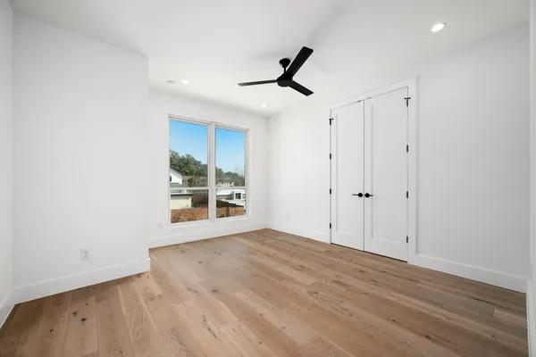 a view of a house with backyard and a tree