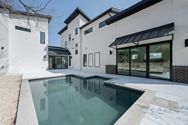 a view of a house with snow on the road
